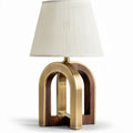 Arch table lamp with brass and wooden base and white fabric shade